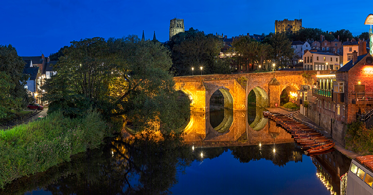Elvet Bridge in Durham City during night time with cathedral and castle on a  hill in background